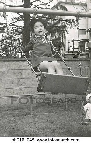 Girl playing on a swing View Large Photo Image Stock Photography - Girl playing on a swing. Fotosearch