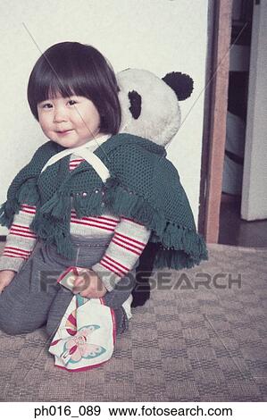 Girl playing with a toy bear View Large Photo Image Stock Photo - Girl playing with a toy bear. Fotosearch
