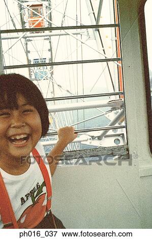 Girl sitting in a ferry-wheel cabin View Large Photo Image Stock Photo - Girl sitting in a ferry-wheel cabin. Fotosearch