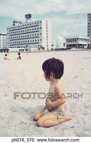 Girl sitting on a beach View Large Photo Image Stock Image - Girl sitting on a beach. Fotosearch