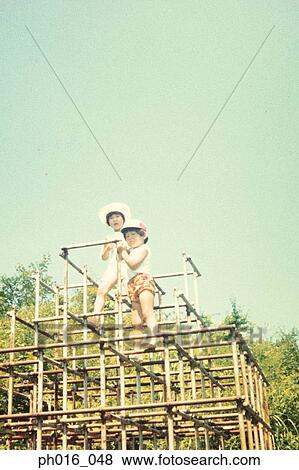 Stock Photo - Girls playing in a playground. Fotosearch