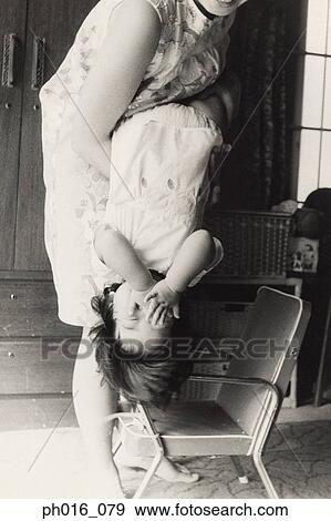 Stock Photo - Mother carrying her daughter. Fotosearch
