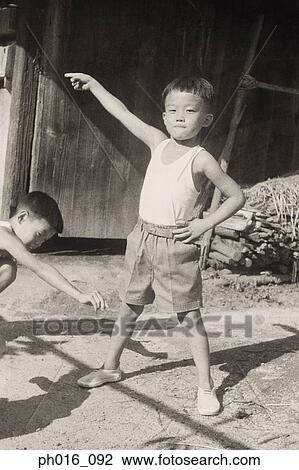 Portrait of boys playing at the backyard View Large Photo Image Stock Image - Portrait of boys playing at the backyard. Fotosearch
