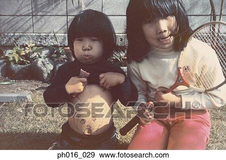 Portrait of two girls making monkey faces View Large Photo Image Stock Photo - Portrait of two girls making monkey faces. Fotosearch