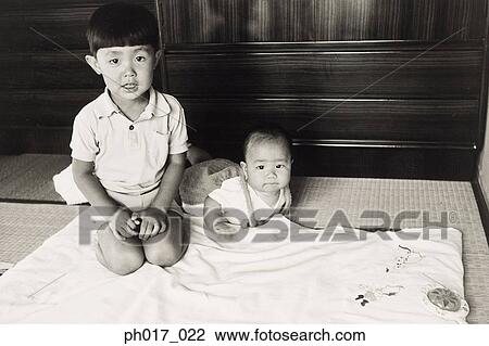 Stock Image - Elder brother and a baby. Fotosearch