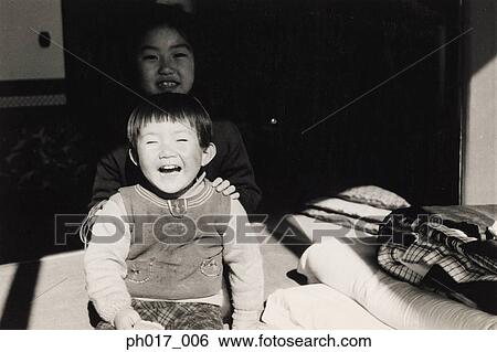 Stock Photograph - Elder sister and younger brother. Fotosearch