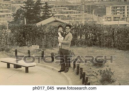 Stock Photography - Father carrying baby boy. Fotosearch