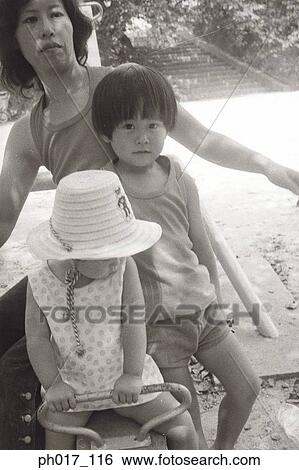 Stock Photograph - Mother and children at playground. Fotosearch