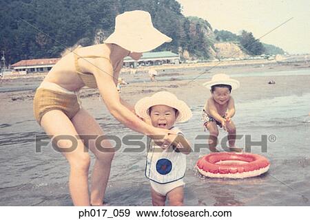 Mother and children at seaside View Large Photo Image Stock Photo - Mother and children at seaside. Fotosearch