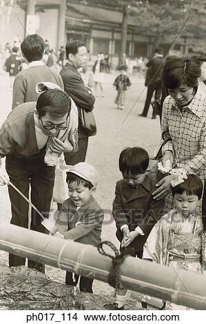 Picture - Parents and children praying. Fotosearch