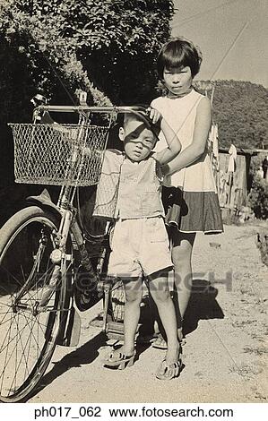 Sister, brother and bicycle View Large Photo Image Stock Image - Sister, brother and bicycle. Fotosearch