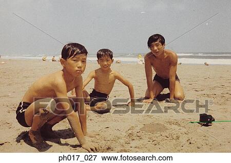 Stock Photo - Three brothers on the beach. Fotosearch