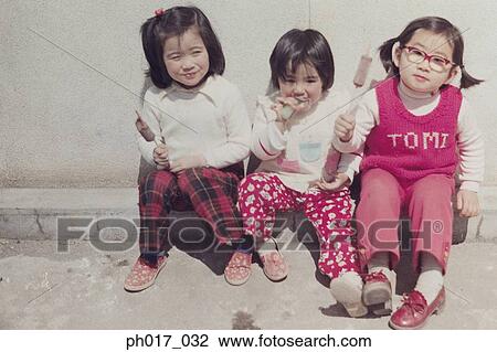 Three sisters eating ice-cream View Large Photo Image Stock Image - Three sisters eating ice-cream. Fotosearch