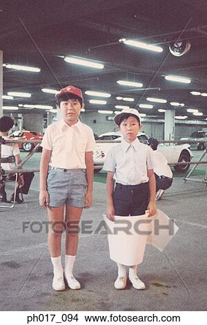 Two boys in a car park View Large Photo Image Picture - Two boys in a car park. Fotosearch