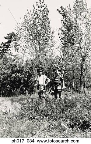 Two boys in a forest View Large Photo Image Picture - Two boys in a forest. Fotosearch