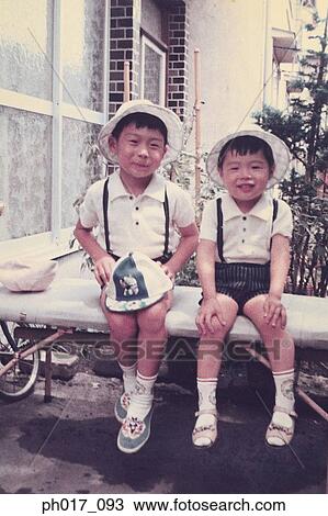 Stock Image - Two brothers at backyard. Fotosearch