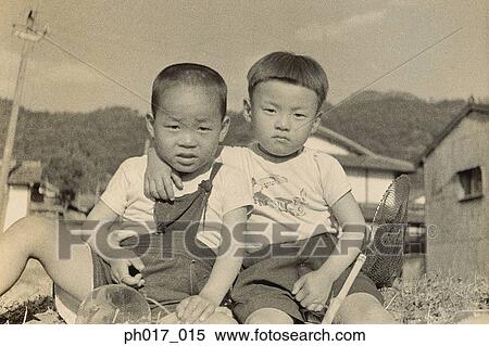 Stock Photography - Two brothers at backyard. Fotosearch