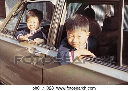 Two brothers in a car View Large Photo Image Stock Photo - Two brothers in a car. Fotosearch
