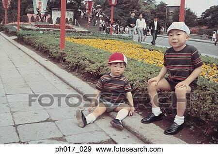Two brothers in a park View Large Photo Image Stock Photo - Two brothers in a park. Fotosearch