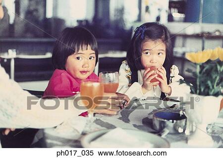 Two sisters at a café View Large Photo Image Stock Photography - Two sisters at a café. Fotosearch