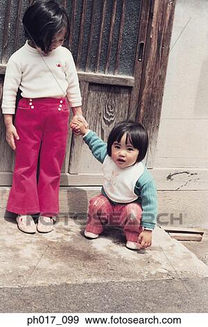 Two sisters at door step View Large Photo Image Stock Photo - Two sisters at door step. Fotosearch