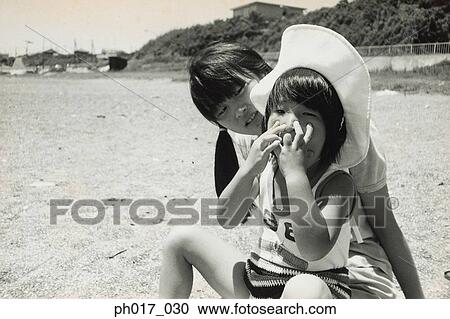 Two sisters on the beach View Large Photo Image Stock Image - Two sisters on the beach. Fotosearch
