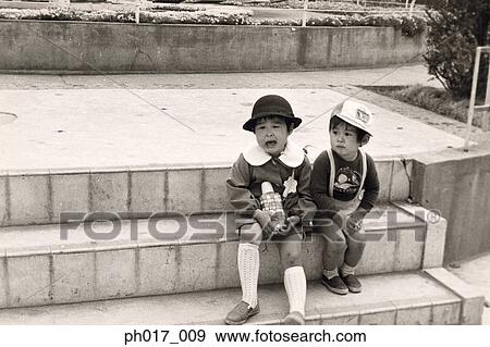 Two sisters sitting on the steps View Large Photo Image Stock Photo - Two sisters sitting on the steps. Fotosearch