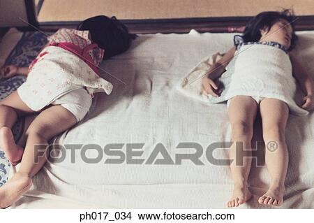Two sisters sleeping View Large Photo Image Picture - Two sisters sleeping. Fotosearch