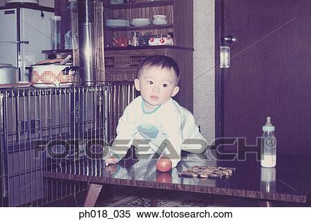 Baby boy climbing up the coffee table View Large Photo Image Stock Photography - Baby boy climbing up the coffee table. Fotosearch