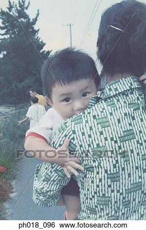 Stock Photograph - Baby boy hugging mother. Fotosearch
