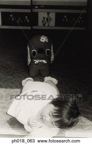 Stock Image - Baby crawling on the floor. Fotosearch