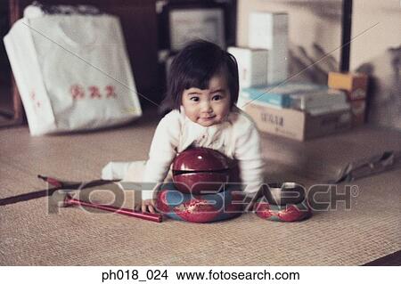 Picture - Baby girl playing with toys. Fotosearch
