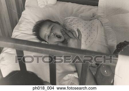 Baby in crib View Large Photo Image Picture - Baby in crib. Fotosearch