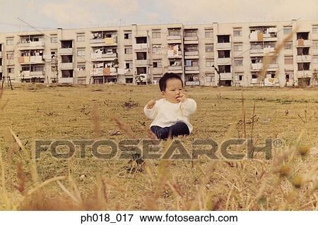Baby sitting in the field View Large Photo Image Stock Photo - Baby sitting in the field. Fotosearch
