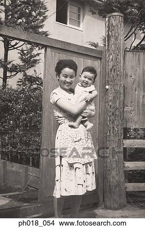 Mother carrying a baby boy View Large Photo Image Picture - Mother carrying a baby boy. Fotosearch