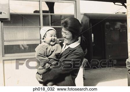 Mother carrying a baby boy View Large Photo Image Stock Image - Mother carrying a baby boy. Fotosearch