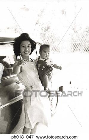 Mother carrying a baby boy View Large Photo Image Stock Photo - Mother carrying a baby boy. Fotosearch