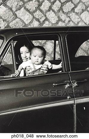 Mother carrying baby boy in the car View Large Photo Image Stock Photo - Mother carrying baby boy in the car. Fotosearch
