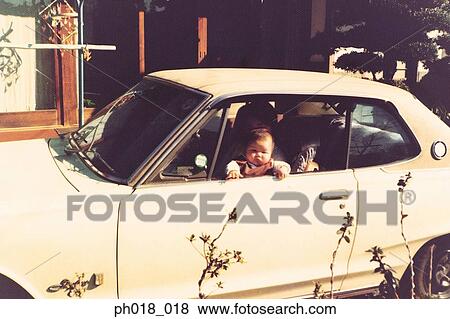 Mother carrying baby on the street View Large Photo Image Stock Photo - Mother carrying baby on the street. Fotosearch