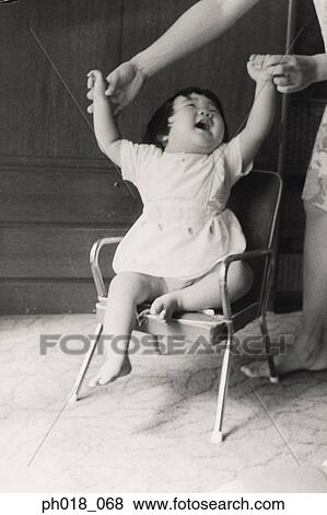 Stock Photo - Mother holding baby girl's hand. Fotosearch