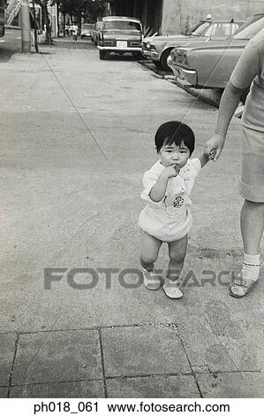 Stock Image - Mother holding baby's hand. Fotosearch
