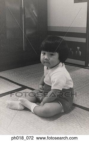 Portrait of a baby girl sitting on the floor View Large Photo Image Stock Image - Portrait of a baby girl sitting on the floor. Fotosearch