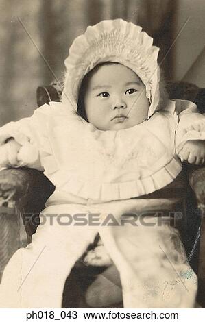 Stock Image - Portrait of a baby in a head dress. Fotosearch