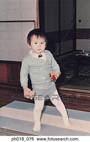 Portrait of a young boy holding toys View Large Photo Image Stock Photograph - Portrait of a young boy holding toys. Fotosearch