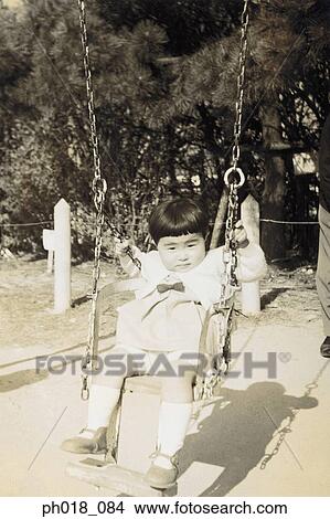 Picture - Portrait of a young girl on a swing. Fotosearch
