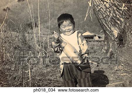 Picture - Young boy holding a bottle. Fotosearch
