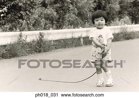 Young girl playing on the road View Large Photo Image Stock Image - Young girl playing on the road. Fotosearch