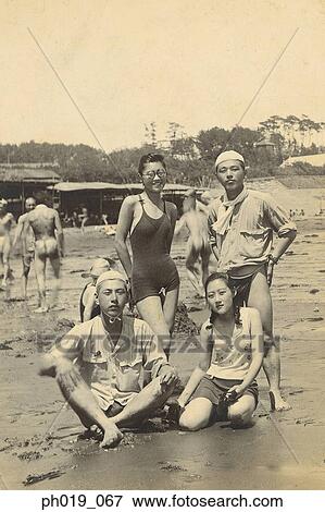 Stock Photo - A group of Asians in beach wear. Fotosearch