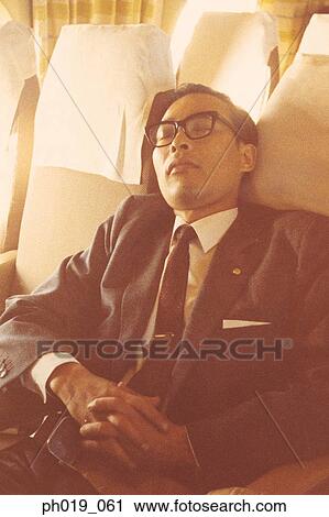 An Asian man sleeping in business attire View Large Photo Image Stock Image - An Asian man sleeping in business attire. Fotosearch