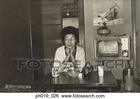 An old Asian woman in the living room View Large Photo Image Stock Photograph - An old Asian woman in the living room. Fotosearch